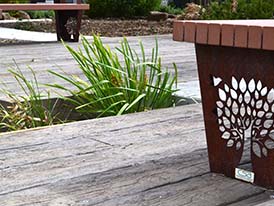 Weathered timber decking and corten steel seats